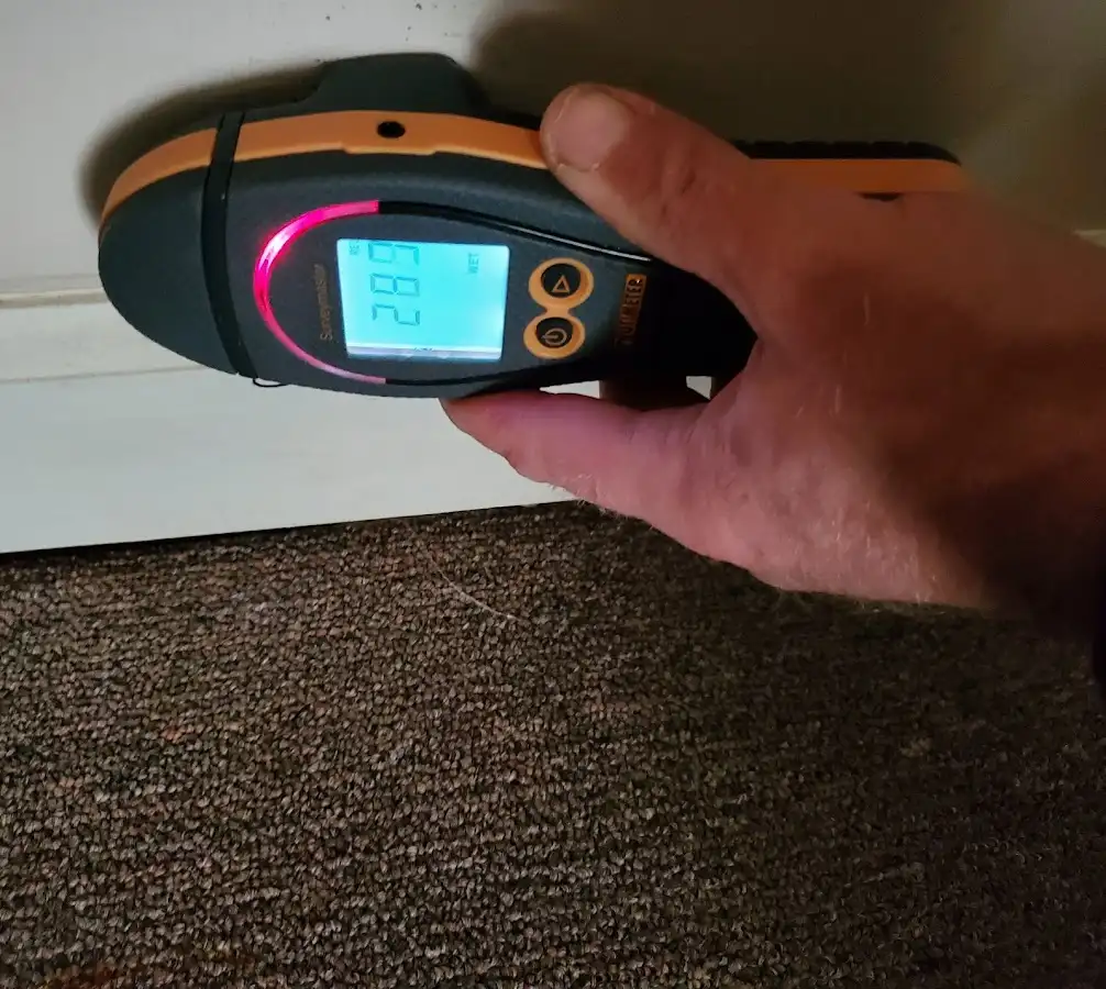 Moisture detection at baseboard during Storm Damage Restoration in North Richland Hills
